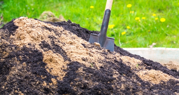 Sand being mixed with soil